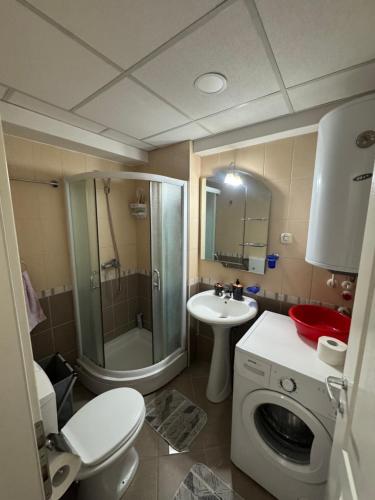 a bathroom with a toilet a sink and a shower at Apartman Harmony in Ohrid