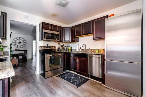 a kitchen with stainless steel appliances and wooden cabinets at Jungle House Luxury Homes - Columbus Downtown Short North - Steps to Convention Center & Nationwide Arena - Sleeps up to 6 - Free Parking - Over 5,800 Five Stars in Columbus