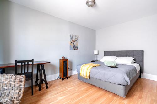 a bedroom with a bed and a desk and a table at Jungle House Luxury Stays - Columbus Downtown Short North in Columbus