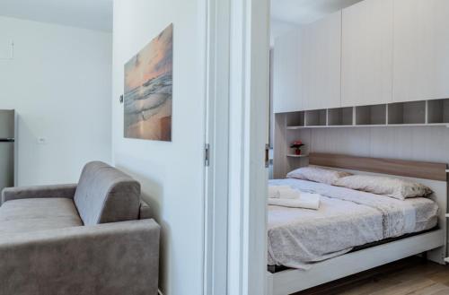 a bedroom with a bed and a chair in it at Tabor Garden near Lake Maggiore by Kibilù Affitti Brevi in Golasecca