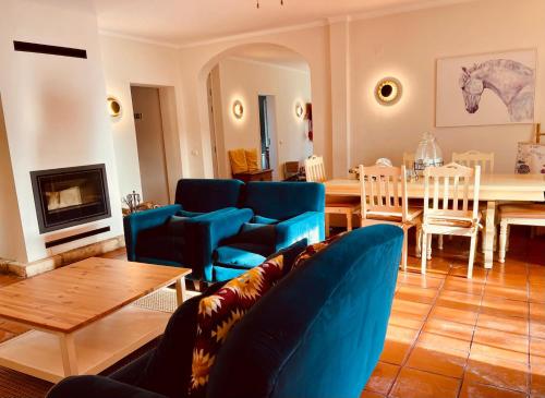 a living room with a blue couch and a table at Marchanta Riverside Hotel in Santarém