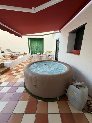 a large hot tub in the middle of a patio at Casa Antigua Arona in Arona