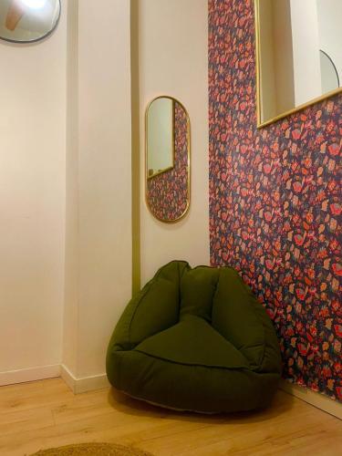 a green bean bag chair in a room with a mirror at Accogliente stanzetta vicina al centro di Torino in Turin