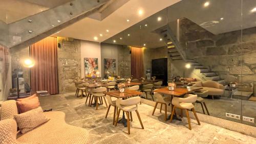 a restaurant with tables and chairs and a staircase at CHARM by YoursPorto in Vila Nova de Gaia