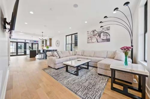 a living room with a couch and a table at Jungle House Premier Residences - Downtown Columbus & Short North in Columbus