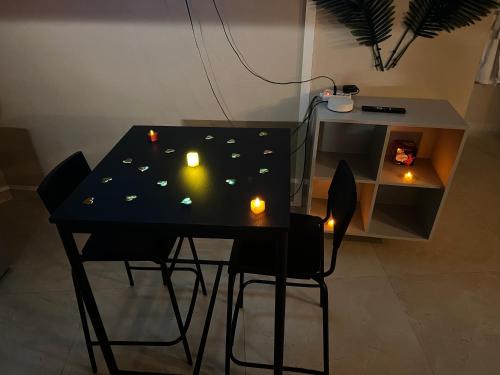 a black table with candles on top of it at Le Cocon SPA Évasion Privée - jacuzzi - in Lunel