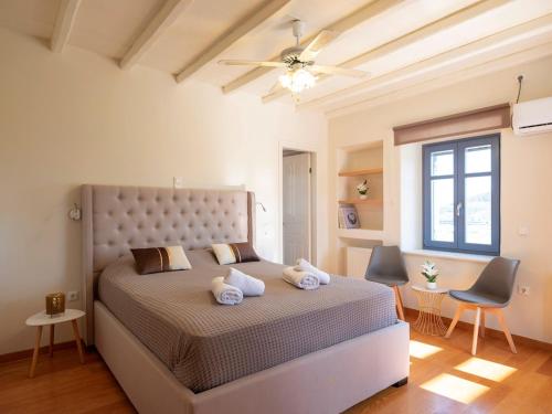 a bedroom with a large bed with two pillows at Paros Tranquility Villa in Dhragoulás