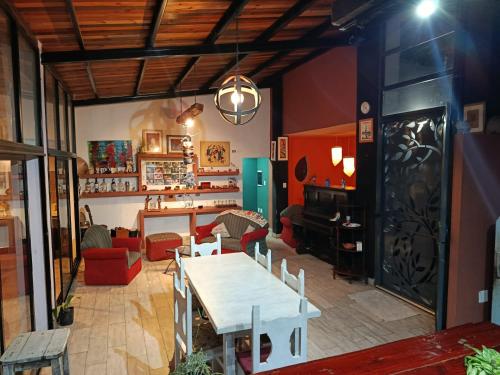 a living room with a table and a piano at Valle Hermoso Salta in Salta