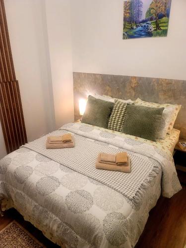 a bedroom with a bed with two towels on it at Warm cozy 1 bdrm close to Hwy in Edmundston