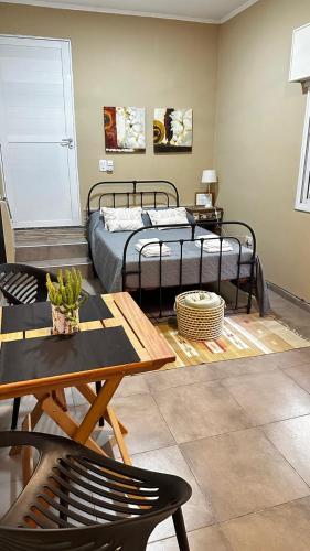 a bedroom with two beds and a table and a coffee table at Casa AMBAR in Concordia