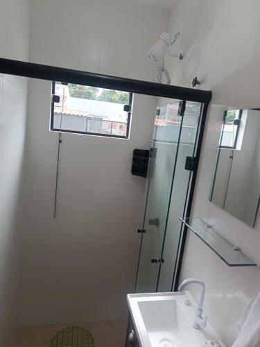 a bathroom with a shower and a sink at Loft mobiliado in Joinville