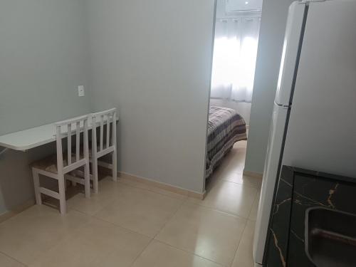 a room with a desk and a bed in it at Loft mobiliado in Joinville