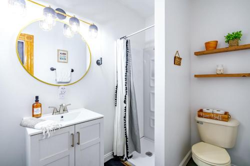 a bathroom with a sink and a mirror at Jungle House Columbus Downtown Free Parking Sleeps 8 - Walk to Convention Center & Nationwide Arena - 1BR Short North Luxury Home - Over 5,800 Five Star Stays in Columbus