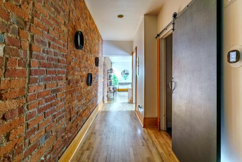 a brick wall in the hallway of a house at Jungle House Columbus Downtown Free Parking Sleeps 8 - Walk to Convention Center & Nationwide Arena - 1BR Short North Luxury Home - Over 5,800 Five Star Stays in Columbus