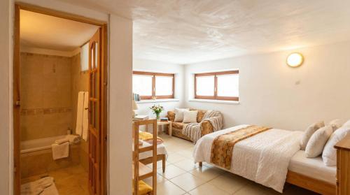 a bedroom with a bed and a bathroom at CHALUPA V ZÁPADNÝCH TATRÁCH in Bobrovec
