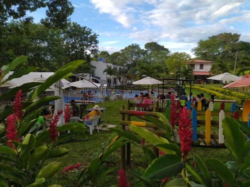 a group of people sitting at tables in a park at Llano grande rivera in Rivera