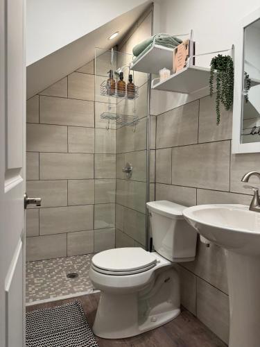 a bathroom with a toilet and a sink at Jungle House Columbus Downtown Free Parking Sleeps 8 - Steps to Convention Center & Nationwide Arena - 2BR Short North Luxury Home - Over 5,800 Five Star Stays in Columbus
