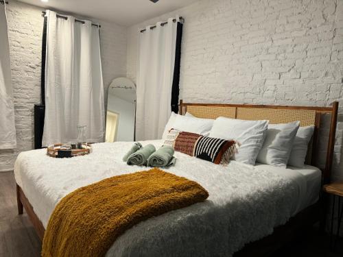 a bedroom with a large white bed with pillows at Jungle House Columbus Downtown Free Parking Sleeps 8 - Steps to Convention Center & Nationwide Arena - 2BR Short North Luxury Home - Over 5,800 Five Star Stays in Columbus