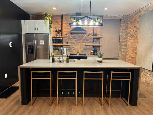 a kitchen with a large island in the middle at Jungle House Luxury Stays - Columbus Downtown Short North in Columbus