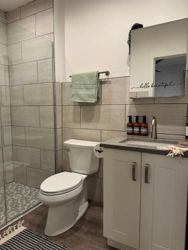 a bathroom with a white toilet and a shower at Jungle House Luxury Stays - Columbus Downtown Short North in Columbus