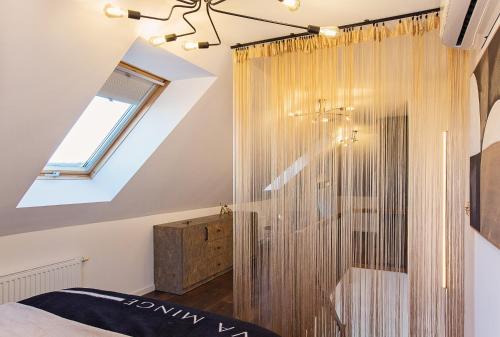 a bathroom with a shower in a attic at Loft Gryfita - butikowy blisko plaży, 2-poziomowy in Szczecinek