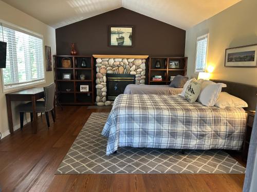 a bedroom with two beds and a fireplace at Whitefish Home, 3 BED 2 BATH, Sleeps 7, Hot Tub, AC in Whitefish