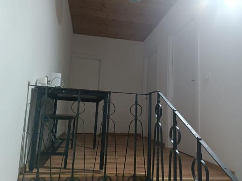 a staircase with a glass table and a stool at MTB b&b in Alfonsine