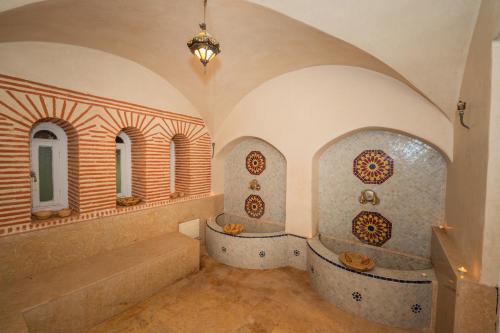 a bathroom with two bath tubs in a building at Mumtaz Dar in Marrakesh