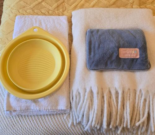 a yellow plate sitting on top of a napkin at Majesticlara Lisbon Guest House in Lisbon