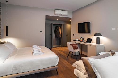 a hotel room with a bed and a desk at Porpora Suite Hotel in Milan