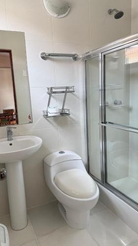 a bathroom with a toilet and a sink and a shower at Casa Elena in Cusco