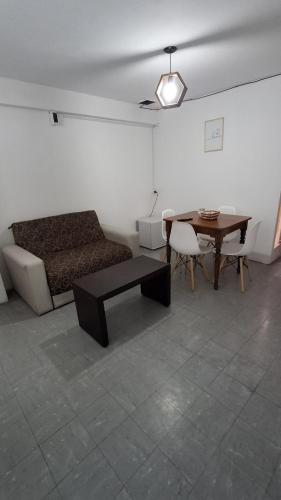 a living room with a couch and a table at SLC San Martín 4 in San Luis