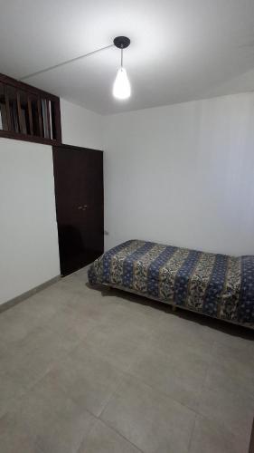a bedroom with a bed and a ceiling fan at SLC San Martín 4 in San Luis