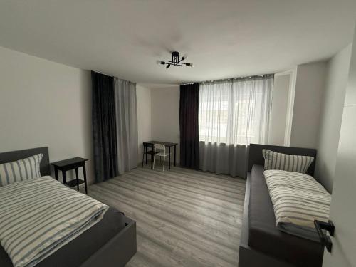 a hotel room with two beds and a window at Sofia2 in Urschmitt