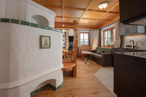 a kitchen and a living room with a fireplace in a house at Brandhof in Ramsau am Dachstein