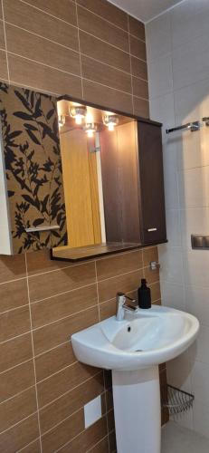 a bathroom with a white sink and a mirror at Casa La Mata in La Mata
