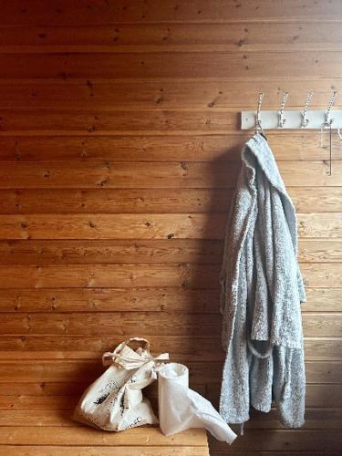 a pair of shoes and a towel hanging on a wall at Varangertunet Wilderness resort in Jakobselv