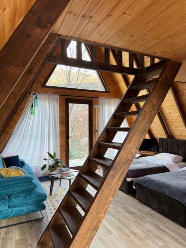 a room with a wooden staircase in a house at Agora Farmhouse in Koman