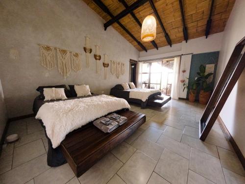 a bedroom with a bed and a couch in a room at Casa NATIVO in Jardin