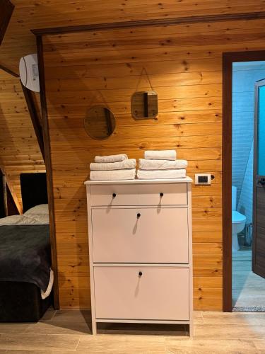 a bedroom with a white dresser with towels on it at Agora Farmhouse in Koman