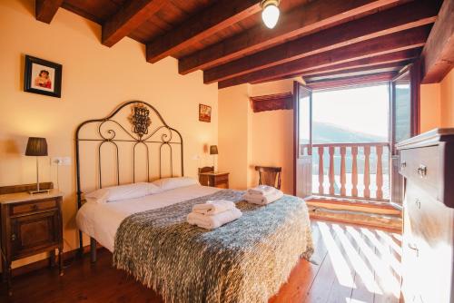 a bedroom with a large bed with towels on it at Can Bonada in El Serrat