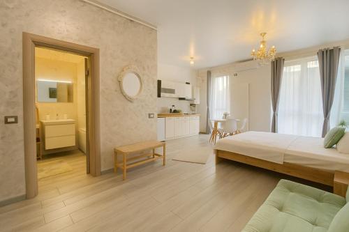 a large bedroom with a bed and a kitchen at Sasha Collection by AlezziNord10 in Constanţa