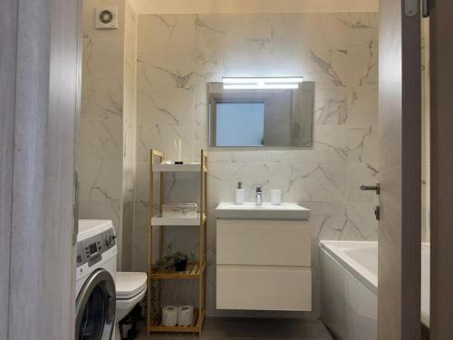 a bathroom with a sink and a washing machine at Sasha Collection by AlezziNord10 in Constanţa