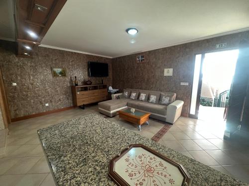 a living room with a couch and a table at The House of Passos in Ponta do Sol
