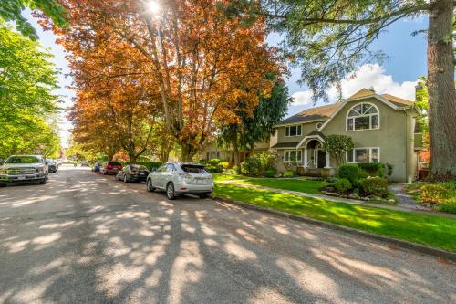 a house with cars parked on the side of the street at BudgetWise Semi-Basement near Airport, UBC, Downtown in Vancouver in Vancouver