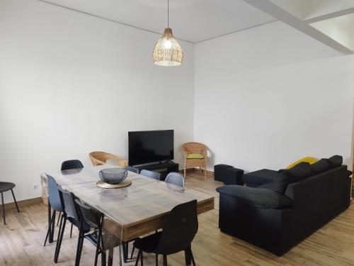 a living room with a table and a couch at Chill Spot - Faro Hostel in Faro