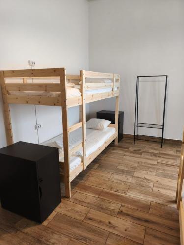 a room with two bunk beds and a mirror at Chill Spot - Faro Hostel in Faro