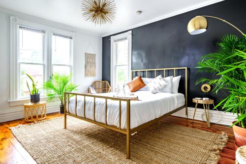 a bedroom with a bed with a black wall at Jungle House Luxury Stays - Columbus Downtown Short North in Columbus