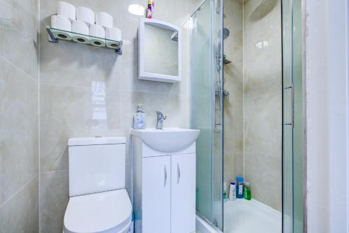 a bathroom with a shower and a toilet and a sink at Royal London Hotel in London