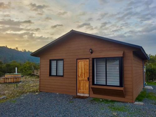 a small shed with a door in a yard at Cabañas Cocodrilo Lodge in Molina